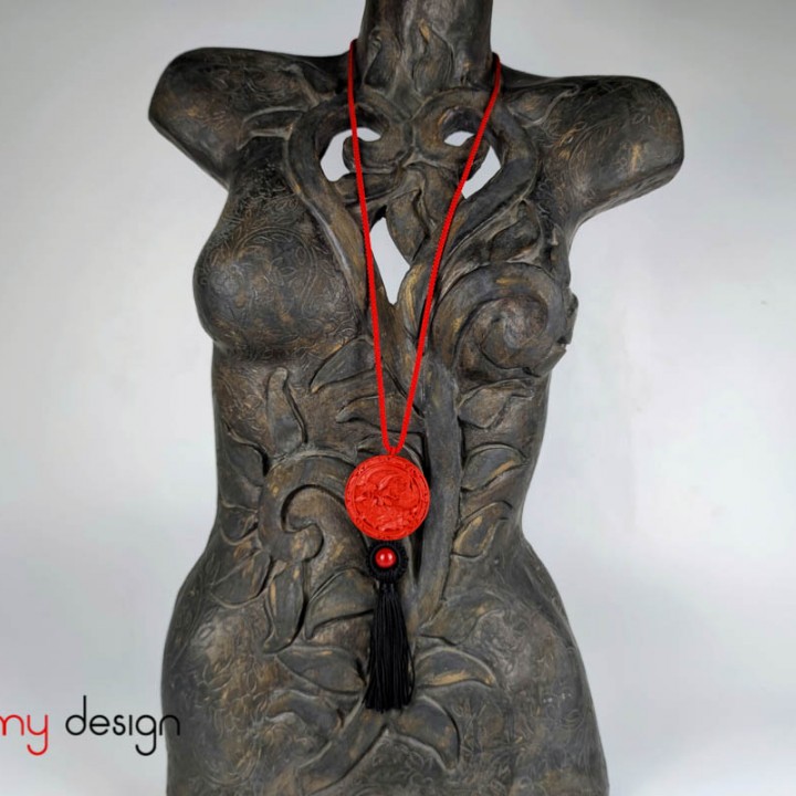 Necklace designed with silk strap with round pendant engraved flower and bird, black tassels