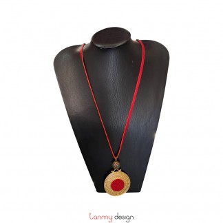 Gold-colored metal pendant necklace, red leather and colored metal beads.