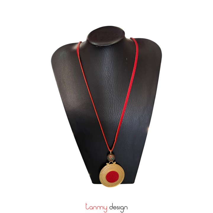 Gold-colored metal pendant necklace, red leather and colored metal beads.