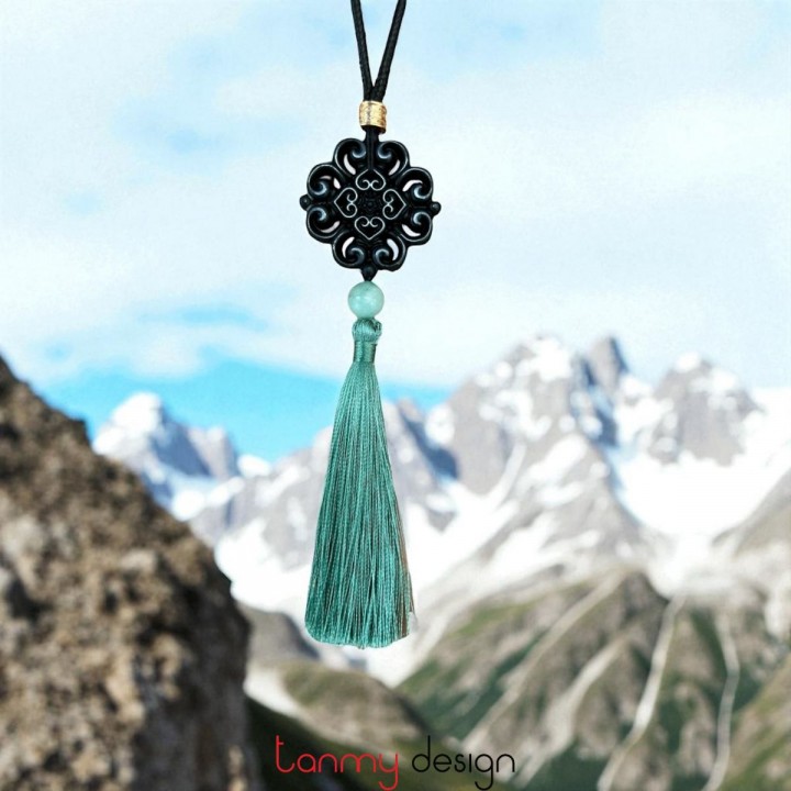 Necklace designed with carved black marble and green tassel