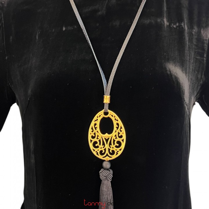 Necklace designed with  metal with black tassels